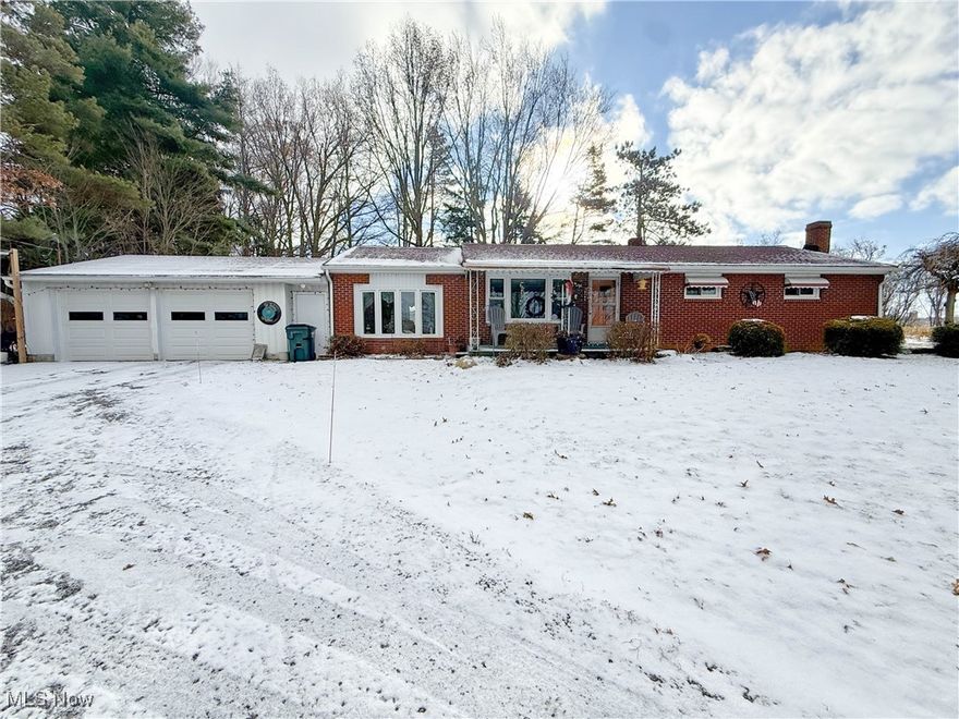 This 3-4 bedroom, 2.5 bath, brick ranch in West Branch Schools is a rural gem, set on 1 acre of country property, with a welcoming covered porch, a convenient horseshoe driveway and vinyl windows that were updated just a year ago. 
Step inside and discover a layout full of versatility. The original living room, with hardwood floors, is now being utilized as a spacious dining room, perfect for gathering around the table. The breezeway has been converted into a large living room with its own electric baseboard heat, LVT flooring, a bay window, a half bath, and sliding glass doors that open into the 3 season/sunroom, where you can relax and enjoy the views of your own slice of the countryside. 
The kitchen is generously sized with an abundance of cabinetry and counter space, and the stove, refrigerator, and dishwasher all stay. Down the hall, you’ll find three bedrooms—one currently used as a closet, another for storage—and a full bath with a tub/shower combo. The finished basement is a true bonus, offering a rec room/family room with tongue-and-groove hardwood walls and a propane fireplace (the propane tank can stay). There’s also an optional 4th bedroom/office with 2 double closets and a spacious laundry area that houses another full bath (the step-in shower is being used for storage) and a hallway of storage closets. Well and Septic has been inspected. This home offers the space you need, the charm you’ll love, and the country setting you’ve been looking for. Come take a look, you might just picture yourself calling it home.