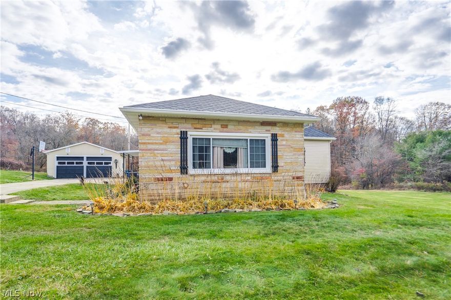 Cozy Country Charm on a 6.76-acre homesite! Step inside to the warmth and character of this inviting 2-bedroom, 2-bathroom home, boasting 1,576 square feet of well-loved living space. The heart of the home features beautiful, five-year-old LVP flooring throughout the dining area and primary spaces. The updated kitchen is a delightful space, featuring refaced cabinets with soft-close hardware and a crisp white backsplash. Laminate countertops and the cozy bar top make it perfect for meals and conversation. The living room offers a comfortable ambiance with wood paneling and a gas fireplace to keep you warm in the winter. A separate, charming dining room with its own gas heater offers flexibility for more dining space. There are two bedrooms with LVP flooring and ample closet space. The main floor full bathroom features a single vanity and a tub/shower. The basement features a rec room and a potential third bedroom, which also has the second full bath. The true bonus of this property lies outside, offering incredible space for hobbies or storage. The yard is an edible landscape, boasting apple and pear trees that produce fruit, as well as blackberry bushes. A two-car detached garage, a shed, and TWO massive outbuildings with power provide storage and workspace. You don't want to miss your chance to see this beautiful property; schedule your showing today! (Windows, roof, and siding have all been done within approximately the last 6-7 years. Also, the property has mineral rights and free gas.)