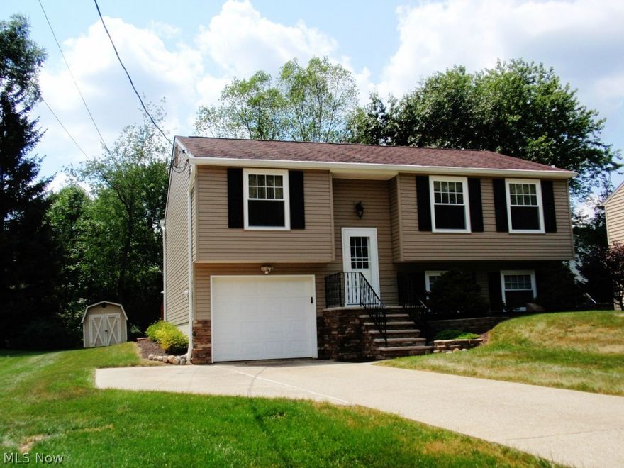 Welcome to this desirable and perfectly maintained 3BR 2.5 bath home on a nice lot. This home features lots of upgrades that include: roof-2003, vinyl siding, new front porch, lower level bath w/double shower-2014, furnace & A/C-2005, carpet in all rooms-2009, new tilt-in windows-1999 w/ transferable warranty, multi-level deck power washed-2015. The kitchen has Medallion cherry cabinets and lots of counter space for the chef in the family. There is a small built-in TV screen on the kitchen wall to enjoy while preparing meals. A breakfast bar divides the kitchen and dining room for those lunch time snacks. The bedroom in lower level is being used as an office/playroom. If you are an Indians fan, you will love the decor in the family room. The full bath in the lower level has an oversize double shower and large vanity. The laundry room has utility tub and option for either gas or electric dryer hookup. You will enjoy the double tiered deck for summer cookouts and relaxation. The home is