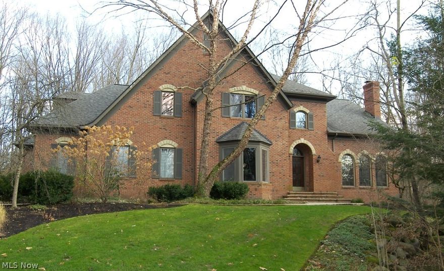 As you drive through the woods in this amazing private setting, this beautiful house appears-Welcome to 17131 Hidden Point. This custom-built home has so much charm and detail throughout. In every room you have a sense of privacy and serenity making it feel like a vacation home. The two-story foyer with wood flooring opens to the living room with a fireplace with gas logs and the dining room with a beautiful window. Tucked away is the library/office with custom built-ins and a gas fireplace and bar area, perfect for a quiet getaway. A two-story family room features wood flooring w/carpet inset, fireplace and beautiful architectural wood cabinetry with a wall of windows and is open to the kitchen. The chef’s kitchen presents natural cherry flooring, an abundance of cabinets, stainless appliances, a center island and a separate dining area with sliding doors to the sunroom. The back hall has a walk-in pantry, a mud room with cubbies and first floor laundry. All bedrooms are on the second