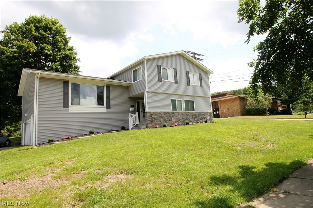 WOW! This absolutely stunning multi level home in West Akron has been completely redone. Nothing to do but move in! Come on in from the covered front porch through the gorgeous front door to the foyer, offering LVP flooring throughout this bright first level to the modern all open living room with an electric fireplace, recessed lighting, abundant of newer windows to let the natural light shine through, new thermostat, dining area and kitchen. This bright and cheerful, picture perfect, kitchen offers abundance of new cabinets, Quartz counters, stainless steel appliances and hood, modern pennants. Upstairs you will find 4 large bedrooms with new carpet, new lighting, new modern blinds. The bright, guest bath totally redone with shiplap wall, new vanity, granite and modern lights, new toilet, sink, shower surround. Large master suite offers 2 closets, master bath everything new with a tile shower, rain head, recessed lights, vanity, sink, toilet and modern lights. The lower level family
