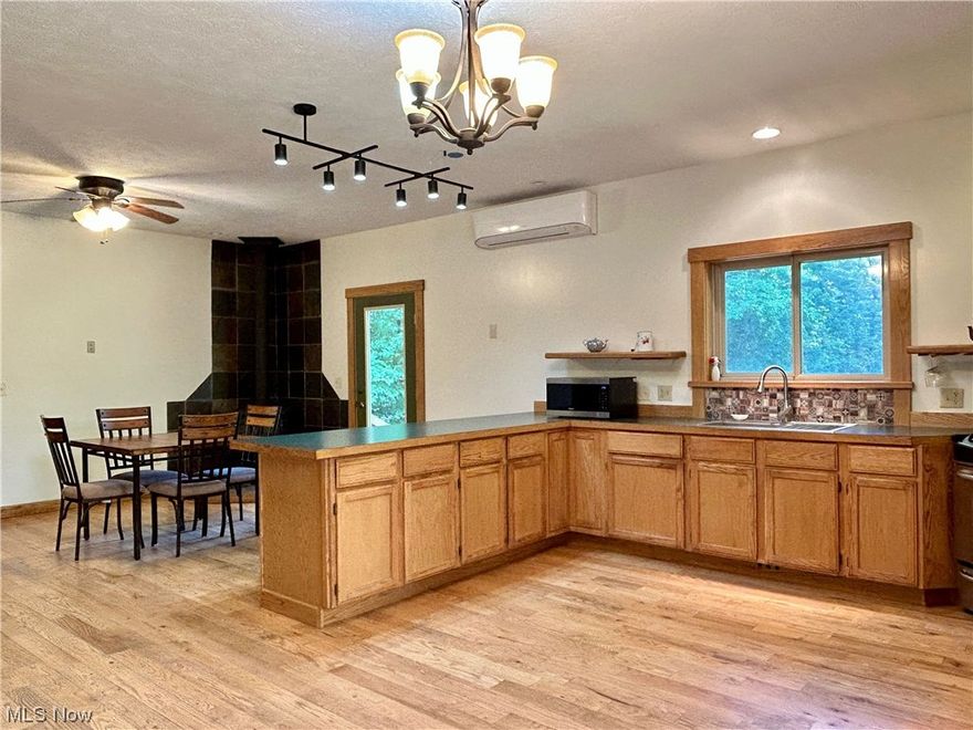 Amazing, one of a kind home on 6.75 acres in Thompson. This property was built by the owner, and features 2x6 walls for additional insulation, plumbing in place to add underfloor heat if desired, and lots of room to just move in and enjoy. Seller is offering a home warranty for full piece of mind.

Welcome to your quiet country life, tucked down a curved driveway in the woods. Step inside to the open plan kitchen/ dining area with wood burning stove, and door to the stone patio with views of the pond. The great room lets in amazing natural light on both sides, and up the spiral stairs is a charming loft, perfect for an office library, studio or even a bedroom if desired. Look out the high windows in the vaulted ceiling to the views of trees and clouds all around you. The bedrooms are on either ends of the house, and each has its own full bathroom adjacent. The master bedroom has a door to the patio also. There is a laundry/ mud/ utility room off the kitchen with a half bath that leads to the huge attached 3 car garage, perfect for storing your toys, lawn equipment, and wood for the stove. Outside is a path leading around to the walk out basement, which is waiting to become a man cave, workout room, woodworking room, or all three. 

The gardens have beautiful stonework, all sourced from the property, wide open green space for recreating and relaxing, and a lovely pond, as well as woods all around. Zoned heating and cooling with mini-split systems in most rooms.