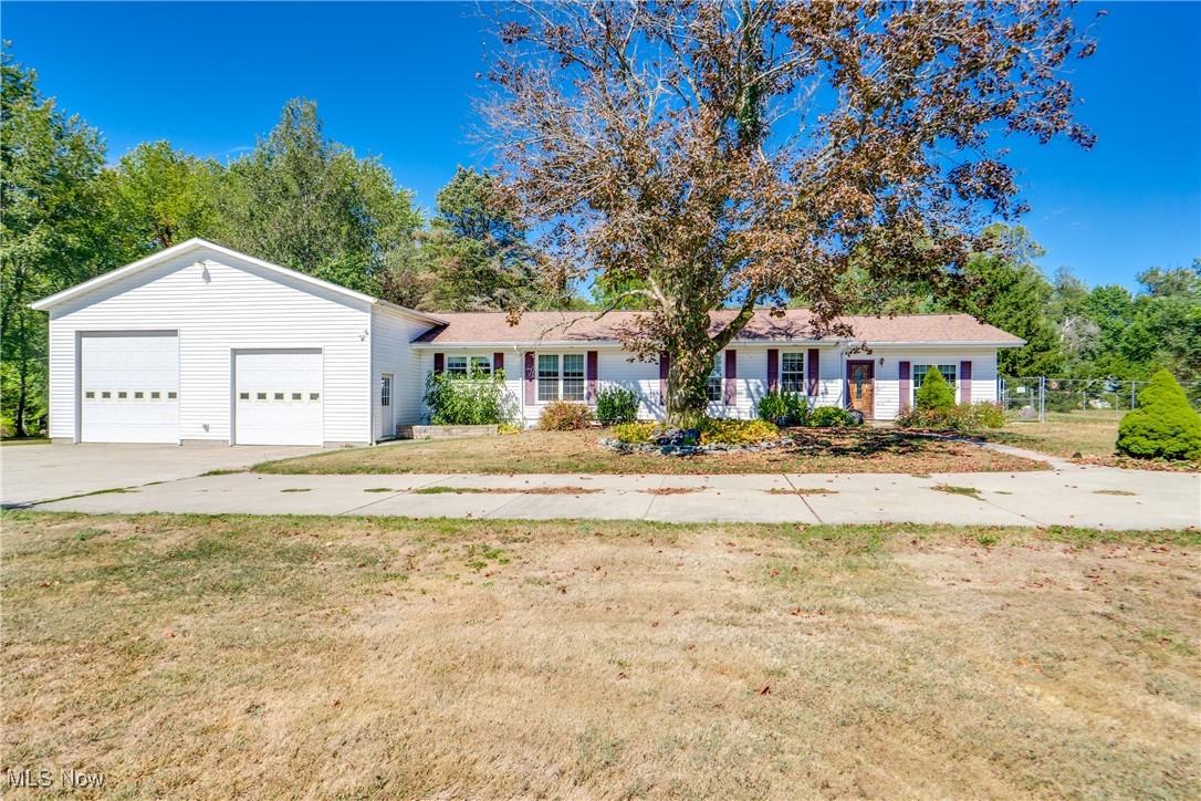 Own a little slice of country! This 1950-built ranch has undergone major improvements over the years and has so much to offer! Let's start with the beautiful 2.5-acre lot, which has a fenced area and a perfect amount of trees for privacy. Then, let's focus on the overall size of the home at 2,240 square feet (not including the 3-season room), which is definitely larger than average. Are you a car enthusiast, have lots of toys, an RV, a boat, or need a large workshop area? The home offers an almost 1,500 square foot attached garage with one door being tall enough for an RV. Plus, there is a detached garage at nearly 900 square feet that is fully insulated, heated, has a loft, and has 220 on two of the walls. Both garages have 200-amp service to make sure you can run all the equipment you may need. There is a lot to love on the inside of the home as well. Kitchen and baths sell homes, and you will love this kitchen! Remodeled with maple cabinetry, granite tops, stainless steel appliances, an oversized island with prep sink and seating for 6 or more, plus a walk-in pantry. Off the kitchen is a formal dining room (currently an office) for special occasions. At the rear of the home, you will find a large vaulted family room with access to the basement and the 3-season enclosed porch. The owner's suite has a walk-in closet plus a private full bath with a soaking tub and a large tile shower. There are two other nicely sized bedrooms plus a second full bath with a tile floor and a walk-in shower. We can't forget the first-floor laundry room and front living room, offering a great space to relax and take in the views from the front of the home. We would love to show you this home as well as provide you with a complete list of improvements. So many possibilities!