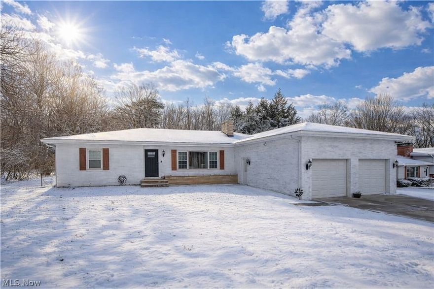 Welcome to this beautifully updated split-level home in the Taylor Manor neighborhood of Wooster. This 3-bedroom, 1.5-bath property offers over 2,000 sq ft of finished living space and sits on a comfortable 0.40-acre lot. The painted brick exterior with wood shutters and individual garage doors provides great curb appeal! Inside, enjoy new flooring throughout most of the main level, the living room is welcoming and inviting, bright with large windows and a fireplace, and an open flow into the eat-in kitchen featuring 2023 cabinetry, newer stainless steel appliances, stone backsplash, breakfast bar, and wood accent beams. Three bedrooms share an updated full bath with farmhouse-style finishes. The lower level offers a great spacious family room featuring a decorative and functional wood accent wall, you'll find a half bath, big closet space, garage access, and walk-out to a cozy covered porch leading to the backyard. Additional living space includes a partially finished basement with a rec room and bonus room ideal for an office or flex space, plus an unfinished area with laundry and ample storage. Conveniently located near schools, shopping, and routes—this home is move-in ready and full of charm.