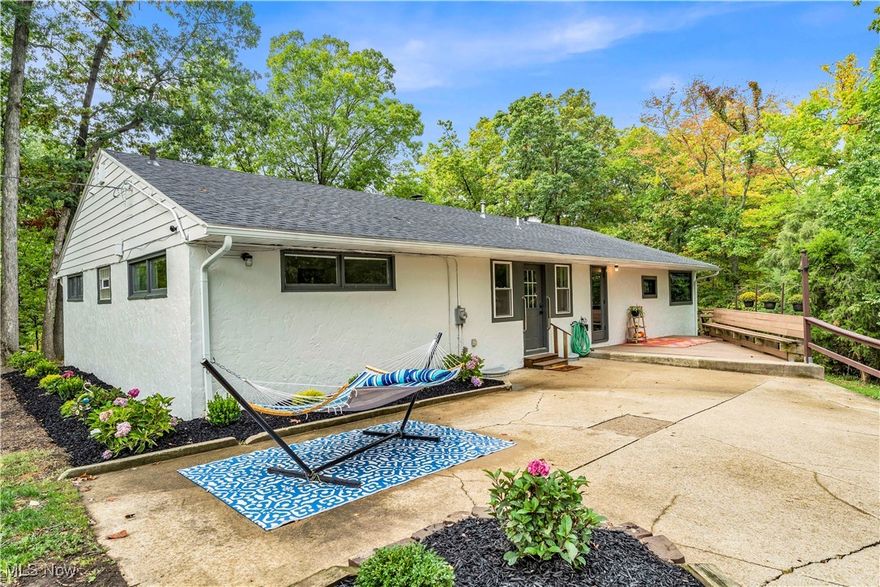 This beautifully updated 4-bedroom, 2-bath ranch offers over 2,000 square feet of single-level living on a rare 1.74-acre wooded corner lot in Seven Hills. Nearly every detail has been remodeled with quality craftsmanship and materials.
The home features a brand-new kitchen with walls opened up for an open-concept flow into the dining and living areas. A new dedicated primary suite was created, complete with its own brand-new bathroom, giving the home a true owner’s retreat. Updates also include new cabinets, countertops, fixtures, trim, and lighting throughout.
Major improvements have been completed for peace of mind, including a new roof, new windows, new HVAC, freshly painted siding, new decking, and a resealed asphalt driveway. Inside, you’ll find fresh paint, new trim, and stylish fixtures that give the home a clean, modern look.
The setting is what makes this property truly unique. The parcel directly behind the home is public land, ensuring lasting privacy and a serene natural backdrop. Mature trees surround the property, creating a peaceful retreat at the end of a quiet dead-end street.
Additional features include a spacious living room with hardwood floors and a fireplace, a partially finished basement with a second fireplace, and an attached garage with a paved drive. With all the heavy lifting done, this home is move-in ready and offers both comfort and long-term value.