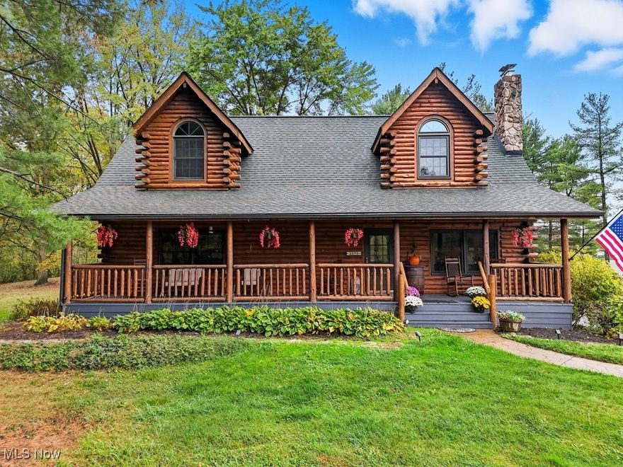 Live every day surrounded by nature’s beauty in this custom log home, situated on 2.7 acres, with a 3 car garage!  You will fall in love with the open concept great room, dining room and kitchen- accented by soaring vaulted ceilings and natural wood beams! The kitchen boasts stainless appliances, solid surface counters and access to a 3-season room, ideal for entertaining, overlooking the wooded back yard. The first floor owners’ suite offers heated floors and a large en suite full bath-complete with jetted tub and shower and updated vanity- as well as a private morning room for you to enjoy your morning coffee, or unwind after a long day.  Hardwood floors thru-out and an additional bedroom with built-ins complete the first floor of this home. The loft offers dramatic views of both the yard and great room below.  2 additional bedrooms and another full bath complete the second floor. The 12-course lower level is ideal for recreation or storage and includes glass block windows. RECENT UPDATES and IMPROVEMENTS include: newer windows in the great room, dining room, loft and dormer; newer roof; newer A/C 2020; boiler valves replaced 2023; exterior of home stained 2024; doors, both front and back porch, down spouts and garage doors painted 2024; sump pump w/battery back-up 2024; chimney sealed and capped 2025.  A rare opportunity like this does not come around very often- do not miss your chance to live in your own personal wooded retreat!