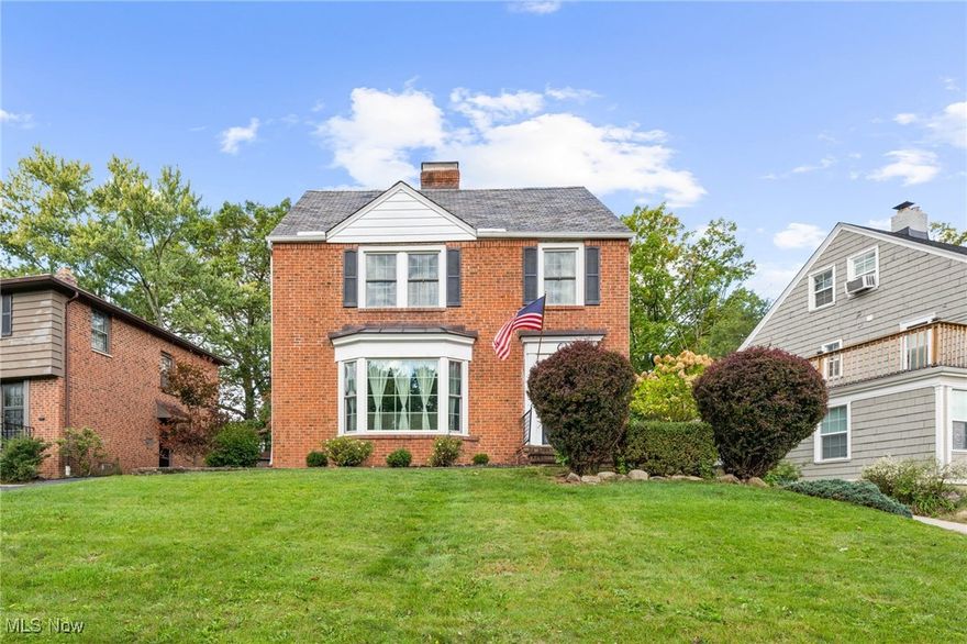 Welcome, This all-brick colonial nestled on one of the largest yards in the neighborhood w/ plenty of space to garden, play, or relax outdoors at the firepit. The slate roof adds to the home's curb appeal. Inside the foyer has a custom tiled entry that will lead you into the living room w/ a newly created brick fireplace surround & mantal. The bay window brings in natural sunlight showing off the real hardwood flooring throughout. You'll find a formal dining room perfect for hosting family & friend w/ custom wainscoting & a corner built in cabinet. The bonus room on the main level is ideal for hobbies, working from home or a playroom. The kitchen has a newer backsplash & newer stainless steal appliances along w/ ample cabinets w/ the additional built in cabinets & floating shelves. 1/2 bath on the first floor is new approx 2021. Heading up the newly added runner to the second floor you'll find 3/4 bedrooms all w/ ceiling fans. The spacious master has a decorative wall of wood. The 3rd floor, with your vision, could be the 4th bedroom retreat w/ its own full bathroom. The bright sunroom on the second floor invites you to morning coffee or afternoon reading. The lower level has a partially finished room w/ a fireplace, glass block windows & plenty of storage. Updates include: newer A/C, blower in the furnace & hot water tank approx 2020. There is also a water filter system. Outside is a nice size wood deck, fenced in rear yard & detached two-car garage. In the rear yard there is plenty of room to play & entertain at the fire pit area. French drains were installed behind the firepit. The expansive yard provides endless possibilities for gardening, entertaining, or for pets to run freely. This classic charming home meets modern flexibility. Located close to dining, shopping & easy access to University Circle, the well known hospital systems & Downtown Cle. This home blends traditional charm with flexible living spaces, making it easy to settle in & make it your own.