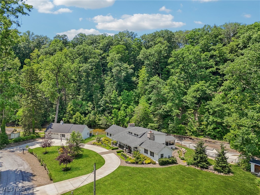 Once in a Lifetime!!!... This rare opportunity presents itself on Cascade Road in Concord Twp. This Cape Design home sits on 2.33 gorgeous acres and overlooks several waterfalls. Breathtaking views from every angle. This home truly is ONE-OF-A-KIND!!! High end finishes can be found throughout with open floor plan. 1st floor owners suite with vaulted beamed ceiling, stone fireplace and slider to backyard patio over looking the falls. Also included w/ owners suite is full glamour bath and ceramic shower and also over looks the falls. 3 bedrooms up with full bath. Spacious kitchen w/ stainless appliances, ceramic backsplash and granite along with breakfast bar and coffee bar that open to dining area. Great room w/ stone fireplace. Sitting area and living room area. Screened in covered deck over looks the waterfalls and leads to stamped concrete patio. Checkout the garage space along with the "Hang-Out" area, it's set up for grilling and for watching all the "Big Games". Too many items to list... only one "LUCKY" buyer will be fortunate to own. Call Greg for questions 440 823 6491