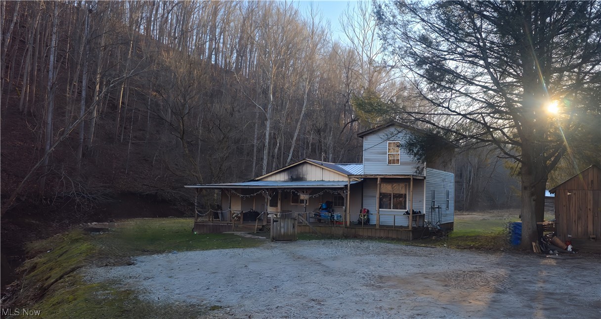 Bye Bye city life...Hello and welcome to W.V. rural living. Here is your invitation to rustic living with this creek side property on 1.5 acres. Nestled in a country setting, this home boasts a smaller footprint but packs a punch with 4 bedrooms, 1 bathroom, eat in kitchen, living room and a laundry room with storage. Inside, the warmth of a wood pellet stove creates a cozy atmosphere, ensuring comfort during colder seasons. The well water source adds a touch of self-sufficiency. This property has a two-story addition, awaiting the finishing touches of its new owner. This presents a fantastic opportunity for customization and personalization to suit your preferences. For those who appreciate the outdoors, you will enjoy having a storage shed and a pavilion, perfect for storing tools, equipment, or hosting gatherings with friends and family. Imagine lazy afternoons spent in the shade of the pavilion, surrounded by the beauty of nature. While this one requires some TLC, it presents a fantastic opportunity for a handy homeowner or an investor and this could be your canvas to create the perfect retreat and enjoy the peaceful lifestyle that comes with owning a slice of rural territory.