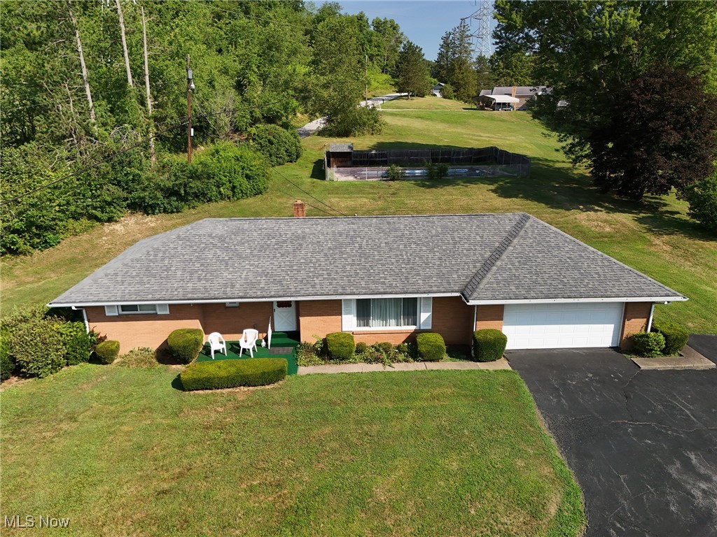 Make this over-sized brick ranch your dream home! This beauty is perfect if you need that extra space for living or entertainment with 4 bedrooms all on one floor or use the one bedroom with the attached bath as a family room. This space is easily modified to meet your needs. Two full baths offers convenience for large bustling households or use the bed and bath on the opposite side of the household for extended family. Enjoy the easy access to a stackable laundry unit upstairs or take advantage of the laundry chute in the main bathroom to drop laundry to the fully equipped laundry area in the basement. The professional waterproofed basement offers tons of space for additional rooms to be finished in downstairs. This house was built to meet the needs of a buyer who needs one story living with no stairs. The yard offers just a hair under an acre of wooded park-like splendor and privacy complete with an in ground fenced in swimming pool. (The pool needs some love and a new liner, but that is well worth the effort. An over-sized two car attached garage will house your cars and still leave room for your favorite outdoor toys.
High ceilings feature classic plaster design rarely found in newer homes. Most of the high ticket items have been completed in the last several years. Just enjoy the retro style in the midcentury modern kitchen and baths or update to your taste and move in. More detail and better pictures to follow.
