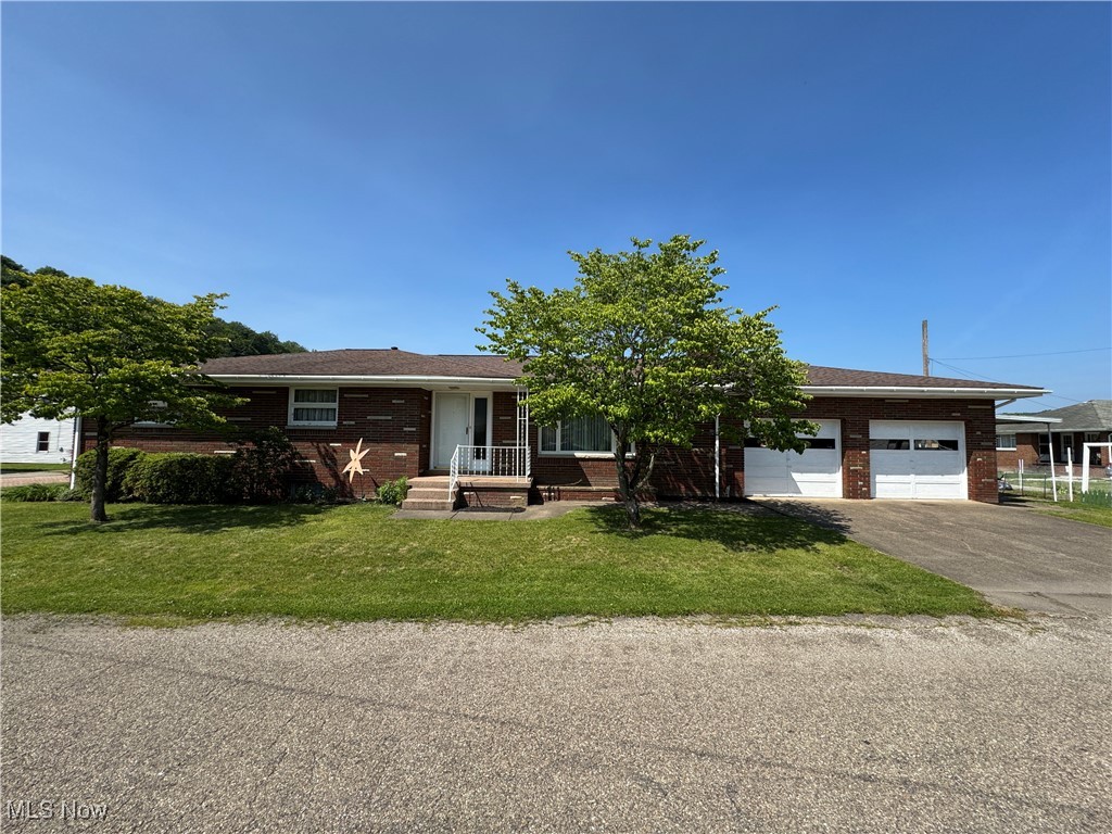Schedule your appointment to see this great new property at 158 Main Street, Rayland, Ohio. This brick ranch has a great flow. Upon entering the front door, you will notice the great hardwood floors in the living room featuring a wood-burning fireplace. Just off the living room is the dining room which then leads into the kitchen that features a great eat-in area. In the rear of the kitchen is a great 3-season room featuring tile floors. Down the hall is 2 bedrooms, a large bathroom plus the primary suite featuring an attached bathroom and nice closet. The basement level features a great wood-burning fireplace which would make for a great future family room. The laundry is also located in the basements as well as a 3rd bathroom that has a walk-in shower (block) that would be great for pets or when doing yard work. The 2 car garage is a great size and on the side of the garage is a carport as well.