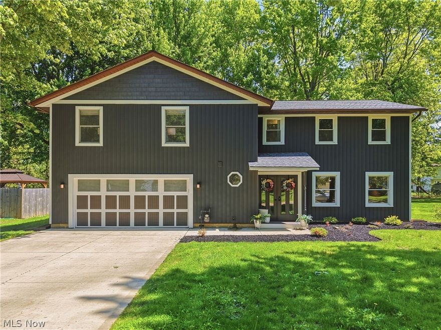 Perfectly positioned just minutes from Mentor Headlands Beach and the shores of Lake Erie, this extraordinary 4-bedroom colonial offers the rare combination of timeless design, thoughtful updates, and true turnkey living. Originally renovated by the renowned Fatica Renovations with exceptional craftsmanship and meticulous attention to detail, the current owner has continued investing extensively in the home, elevating it even further with major mechanical upgrades, beautiful outdoor enhancements, and thoughtful custom finishes throughout. The double door entry opens to the foyer with custom built in seating and storage bench, hooks for hanging and a nicely renovated half bath w stone countertops. The spacious living room filled with natural light seamlessly connects to the dining area and kitchen — a true showpiece featuring quartz countertops, tile and shiplap backsplashes, stainless steel appliances, ample cabinetry, pantry storage, and a center island perfect for gathering. Just beyond the kitchen, a cozy sitting area with a granite-faced fireplace opens into the expansive family room with access to the back patio. The second floor offers four generously sized bedrooms, convenient second-floor laundry, and additional storage space. The sprawling owner’s suite is a true retreat with dual closets and an exquisite spa-inspired en-suite bath. Outside, enjoy a beautifully redesigned backyard featuring a stone patio and wood-burning fireplace — the perfect space for relaxing or entertaining. Additional updates include NEW FURNACE + A/C (2025), NEW 50 GAL HWT (2025), professionally installed French drain systems, extensive landscaping and bedrock beds AND MORE! Nice finishes, extensive updates, and an unbeatable location just minutes from Mentor Headlands Beach, parks, shopping, and dining, this is a truly move-in-ready home offering exceptional value and lifestyle. Schedule your showing today!