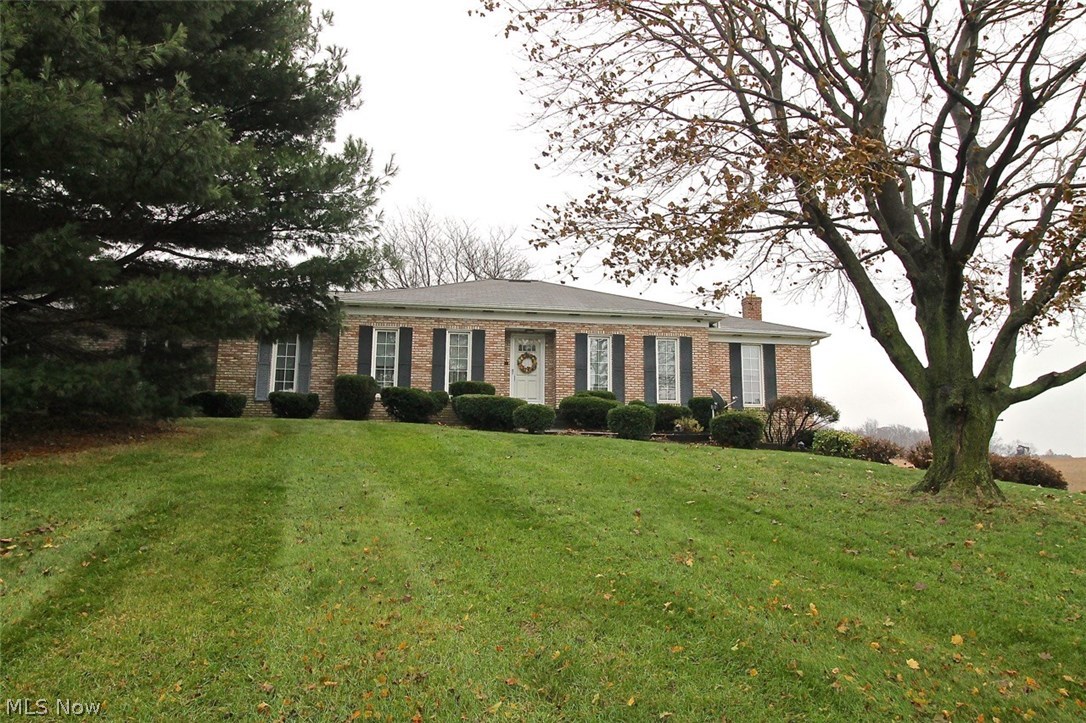 If you are looking for that perfect home on a nice plot of land with mature trees to make all your own, look no further. Take a look at this beautiful three bedroom, two full bath brick ranch home on 1.34 acre of land with picturesque landscape sitting atop the hill. Somewhat of an open concept already, the generous sized living room is open to the dining room which flows nicely through to the spacious kitchen and around the the family room. Easy access from the family room offering built in storage to the nice sized deck overlooking gorgeous farmland. Once you come in from the cold outdoors you can cozy up by the woodburning fireplace for those cold winter nights. Let's talk about the generous sized kitchen with plenty of counter space as well as storage, there is also room for your table and chairs for an eat in kitchen with lots of natural light coming thru. Down the hallway, you will find the master suite as well as two other spacious bedrooms with a full guest bath. As you head d