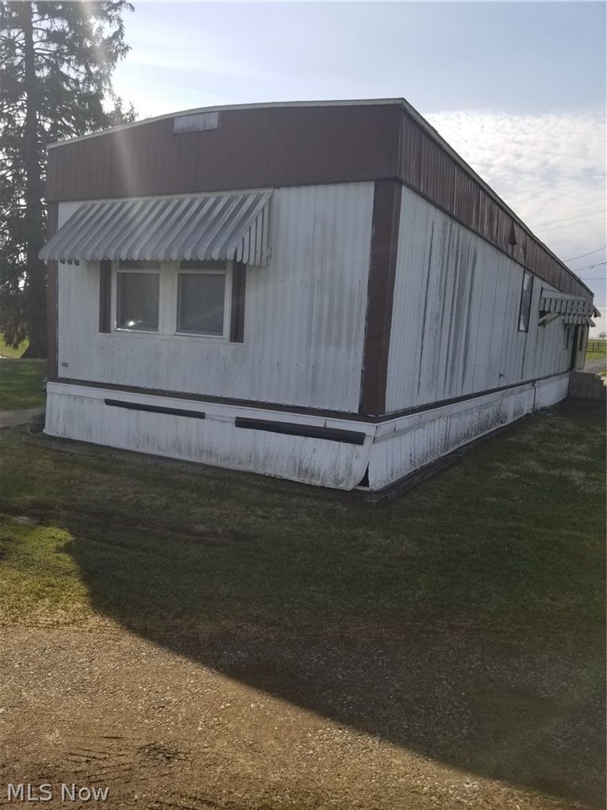 Beautiful 1.79 acres in the country. Older mobile with detached pole garage.Open porch on back.  You can buid your home or stay in mobile. Cash or preapproved loan before showings. No signs on property.