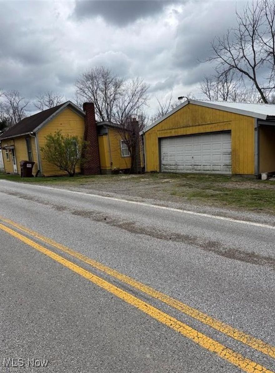 Older one story home that has the utilities shut off for now.  Guernsey Muskingum Electric and Guernsey County Water & Sewer.  Home has two buildings, a 1994 24' x 40' garage with cement floors, electric opener, shelving and a small side porch.  Also a 2006, 24'x 24' wood shop building with an attached carport - RV parking area.  Road frontage on both SR 265 and Old Glory Road. There is 5.63 acres partially wooded and cleared flat land.  Assessment of $2 for MWCD.  Mineral rights Do Not Transfer.  New Survey to be completed on the .25 acre parcel before closing by the seller.