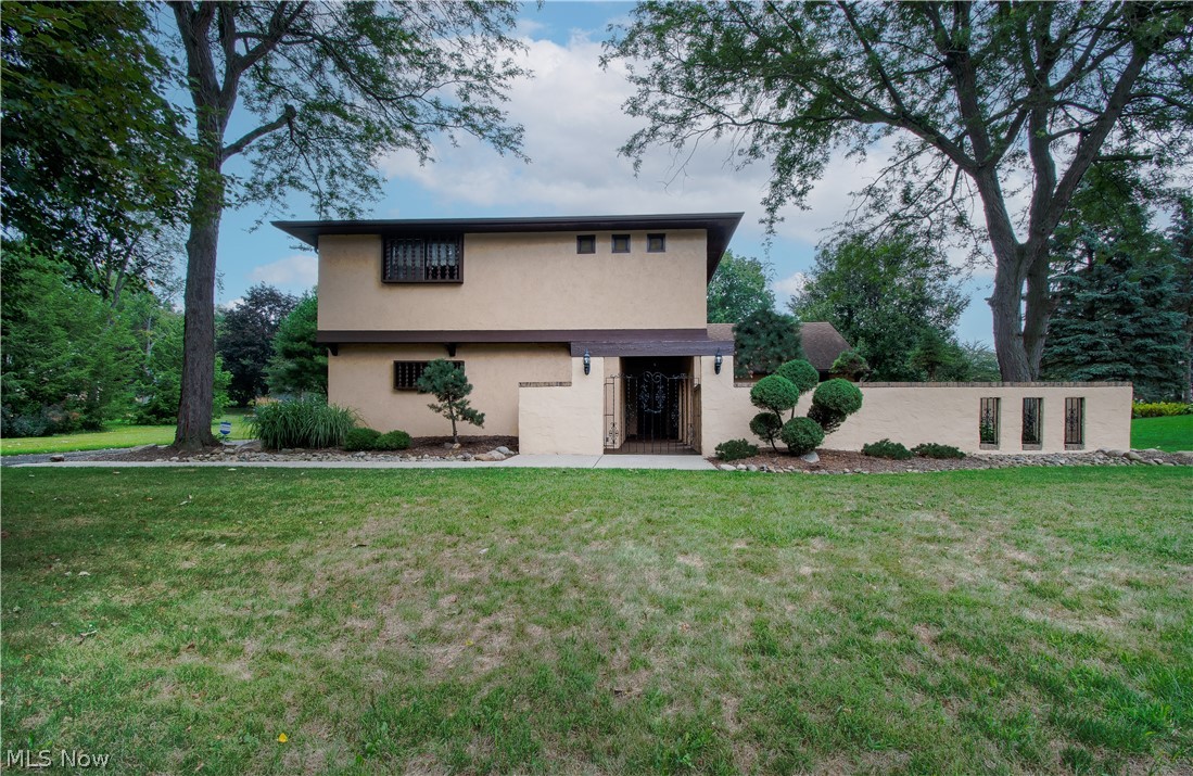Lovely contemporary/Spanish style home on a dead-end street/cul-de-sac in the beautiful Eastpoint community. Enjoy the lighted walking paths and lovely common grounds (which go into Stark Parks). A charming courtyard with a stone patio and a covered front porch welcomes you. This home features four bedrooms, two full baths, a first-floor laundry room, two car garage, and privacy in 2,204 Sq Ft of living area. A large hearth room with a wood-burning fireplace & decorative beams is open to the eat-in kitchen (w appliances/plenty of cabinets/breakfast bar/access to the backyard) and semi-open to the family room, perfect for gathering and entertaining family and friends. A 4th bedroom (or an office), a full bath (with a walk-in shower), a convenient huge first-floor laundry room with lots of storage cabinets and countertop space, and access to the garage and kitchen complete the main floor. On the second floor are three bedrooms (with large closets), including the master's with a sitting a
