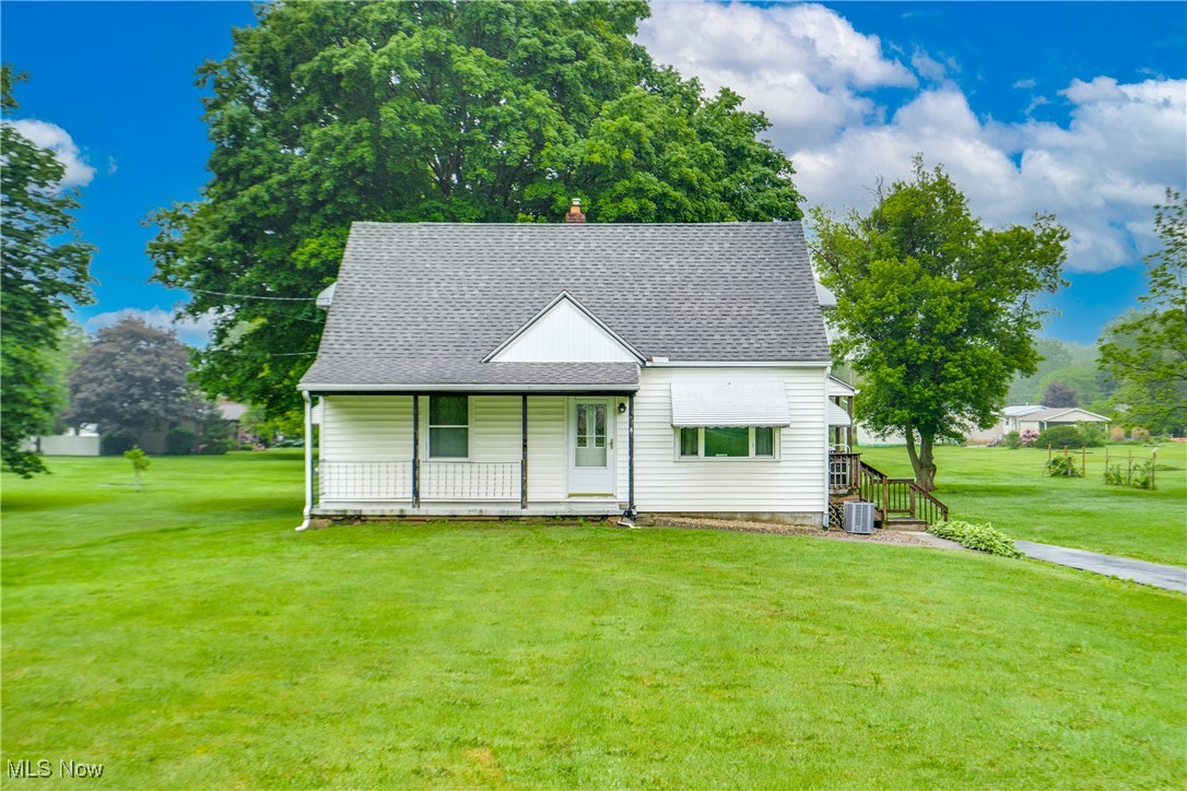 Welcome to this delightful 3-bedroom, 1-bath Cape Cod nestled in the heart of Mogadore Schools. Sitting on an impressive 1.65-acre lot, this home combines comfort, charm, and space — both inside and out! Step inside to find two spacious bedrooms on the main level, each with generous closet space, and a full bathroom conveniently located nearby. The bright and inviting living room offers a wonderful view of the neighborhood, perfect for relaxing or entertaining. The kitchen is a standout feature with ample countertop space, abundant cabinetry, and a view that overlooks the scenic backyard. Upstairs, you’ll fall in love with the cozy third bedroom, beautifully finished with classic knotty pine — a warm and rustic retreat. The lower level offers a clean and versatile area for storage or hobbies, and it walks out to a backyard that’s truly a showstopper. Enjoy the serenity of your private 1.65-acre yard, complete with mature trees, open green space, and an additional barn — ideal for storing lawn equipment, tools, or even turning into your dream workshop. Don’t miss this rare opportunity to own a beautiful home with room to grow, inside and out!