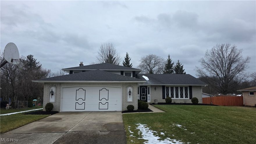 Welcome home to this well-maintained split-level in North Royalton.  This home has been lovingly cared for by its original owners since 1976.  It offers 2.785 sq ft of living space and 4 bedrooms with 2 full & 1 half baths.  Upon entering the home, you are greeted by a spacious and bright living room.  Notice the fresh paint throughout. The large eat-in kitchen is ahead and offers ample cabinets and counterspace.  The kitchen features granite countertops and a tile backsplash, plus all appliances are included.  Access to the covered back patio is through sliding glass doors off the eat-in area, making it easy to dine indoors or outside.  The formal dining room, which is off the kitchen and open to the living room, is perfect for hosting family dinners.  The lower level offers additional living space with a large family room that has a wood-burning fireplace and a wet bar, making it an ideal location to entertain family or friends.  Completing the lower level is a half bath, a bedroom, and the laundry room - washer & dryer are included.  Upstairs, you will find all three bedrooms with hardwood floors.  The spacious master bedroom has a walk-in closet and a full bath with a walk-in shower. There are two additional nice-sized bedrooms, all with ample closet space and another full bath.  This home sits on nearly a half-acre lot and has plenty of space to enjoy outdoor activities. There is an attached 2-car garage.  A new roof was added in August of 2020. This home is ready and waiting for new homeowners to make a lifetime of memories.