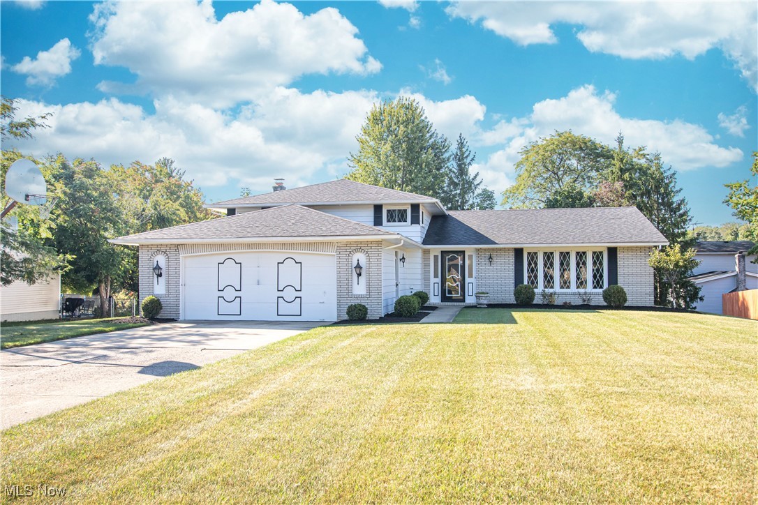Welcome home to this well-maintained split-level in North Royalton. This home has been lovingly cared for by its original owners since 1976. It offers 2.785 sq ft of living space and 4 bedrooms with 2 full & 1 half baths. Upon entering the home, you are greeted by a spacious and bright living room. Notice the fresh paint throughout. The large eat-in kitchen is ahead and offers ample cabinets and counterspace. The kitchen features granite countertops and a tile backsplash, plus all appliances are included. Access to the covered back patio is through sliding glass doors off the eat-in area, making it easy to dine indoors or outside. The formal dining room, which is off the kitchen and open to the living room, is perfect for hosting family dinners. The lower level offers additional living space with a large family room that has a wood-burning fireplace and a wet bar, making it an ideal location to entertain family or friends. Completing the lower level is a half bath, a bedroom, and the laundry room - washer & dryer are included. Upstairs, you will find all three bedrooms with hardwood floors. The spacious master bedroom has a walk-in closet and a full bath with a walk-in shower. There are two additional nice-sized bedrooms, all with ample closet space and another full bath. This home sits on nearly a half-acre lot and has plenty of space to enjoy outdoor activities. There is an attached 2-car garage. A new roof was added in August of 2020. This home is ready and waiting for new homeowners to make a lifetime of memories.