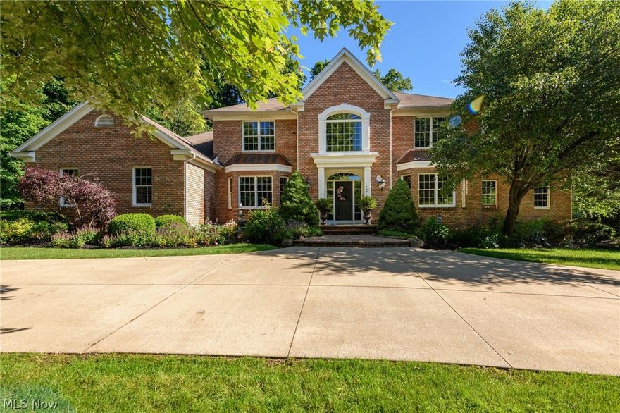 Exceptional beauty, quiet outdoor spaces, and a gourmet kitchen welcome family and friends to this beautiful home.  Filled with natural light and sunny views from tall windows, this home has a spacious floor plan.  The first floor Master Suite includes a walk out to the beautiful, private patio.  The views are spectacular on 2 acres of mature trees.  Spacious outdoor living just off the kitchen make this the perfect layout for entertaining. Visiting guests will enjoy a full kitchen and family room fireplace of their own while staying in the lower level with 2 additional bedrooms.  3 additional over sized bedrooms with new carpet on the second floor.  Beautiful first floor office includes a fireplace.  Enjoy the change of seasons from the beautiful solarium.  3 car garage, circular driveway, gorgeous curb appeal, and a neighborhood of lovely homes.  This quality home has been lovingly and meticulously cared for.  Convenient location to access Akron or Cleveland.  Ready to be yours today.  Welcome home to 213 Taylor James Boulevard.