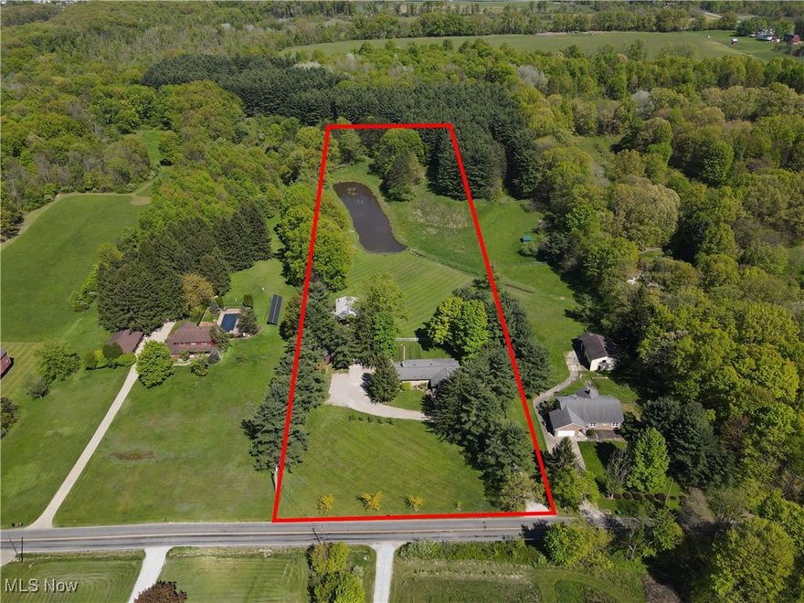 4254 Lakewood Rd Ravenna OH is a beautifully appointed, well maintained, thoughtfully designed property for refined country living @ 6.15 acres of scenic tranquility with pond in Rootstown Township served by Rootstown Schools. Over 3,000 square feet of versatile finished living space: 1,938 square feet on main level & over 1,300sf spacious walk-out lower level. 5 bedrooms (3 1st flr & 2 LL), 3 full baths (Primary, Main & LL), perfect for multigenerational living, entertaining & to enjoy the peaceful surroundings.
Main floor features 3 bedrooms, 2 full bathrooms, plus bright & inviting open plan living room, formal dining room, functional mudroom/ & pantry, designed for everyday convenience & timeless comfort. Kitchen offers lighted cabinetry, workspace, flowing effortlessly into the central living areas, make it perfect for gatherings & daily life.
Walk-out lower level is a true extension of the home, featuring a spacious family room with fireplace, 2 additional bedrooms, beautifully updated full bathroom complete with glass & tile shower. Ample storage, well-appointed laundry, access to the home’s mechanicals, ensuring both function & flexibility.
Step outside to embrace stunning outdoor setting, rear covered porch looking over the pond, leads to custom patio shaded by stylish kite canopy, ideal for relaxing or entertaining. Property is further enhanced by private pond, perfect for fishing, paddling & complete w/ elegant fountains for serenity.
For those seeking space & utility, 6+acres includes two expansive outbuildings, ideal for workshop, home business, recreational storage, equipment, or expansion all surrounded by mature trees & wide-open views offering endless potential for gardening, recreation, or simply enjoying the peace & privacy of country living.
Conveniently located near local amenities & major routes, yet tucked away in a quiet, rural setting in a rare & remarkable property blending classic style, thoughtful updates & unmatched outdoor beauty.