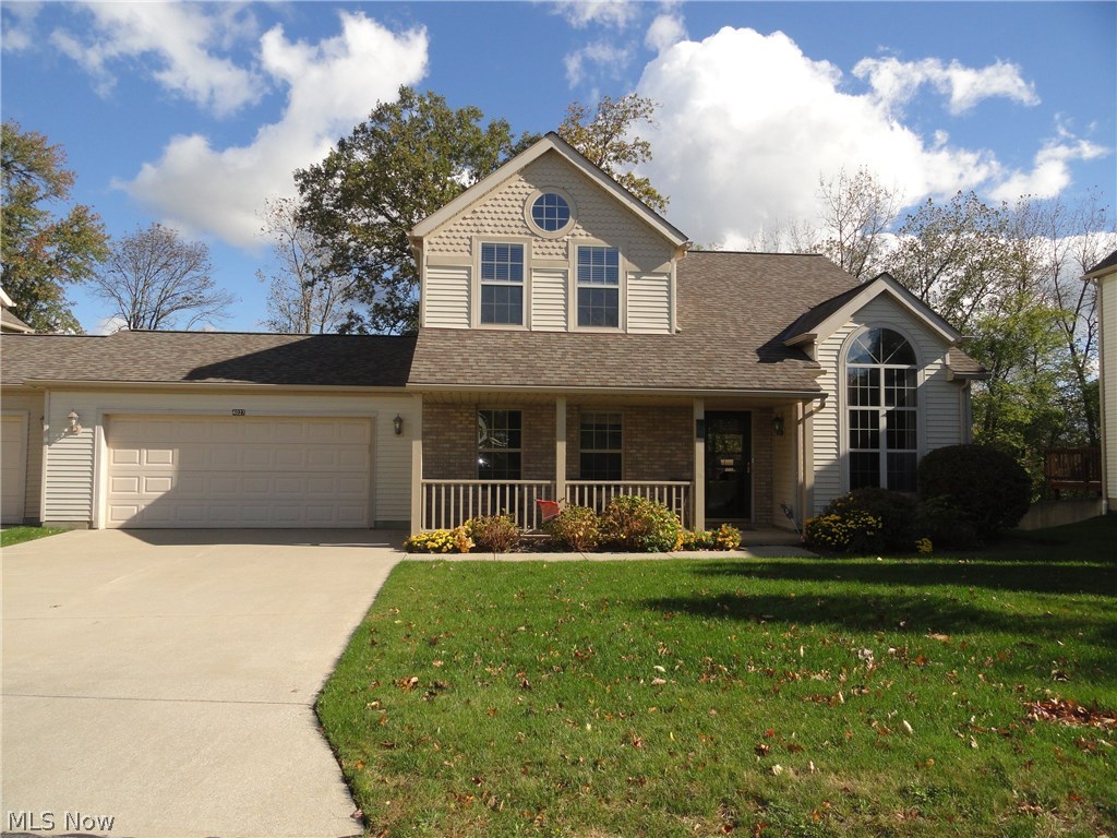 This might be the condo you have been waiting for. Here's an end unit with sharp curb appeal and a welcoming front porch that's large enough for a seating area. Two car garage and double concrete driveway. Bright living room with vaulted ceilings and custom decorative windows open to the formal dining room,beautifully updated kitchen with new cabinets, granite counters, glass back splash, stainless steel appliances and luxury wood like vinyl floor. Large dinette with cathedral ceiling and sliders to the deck porch that overlooks a large lawn and lightly wooded nature preserve. First floor laundry, first floor master w/full bath! 2nd level features large bedroom w/vaulted ceilings, a third bedroom plus a full glamour bath with garden tub and separate shower. Ideal location is close to the highway plus potential membership to swimming and workout room at the adjacent property.