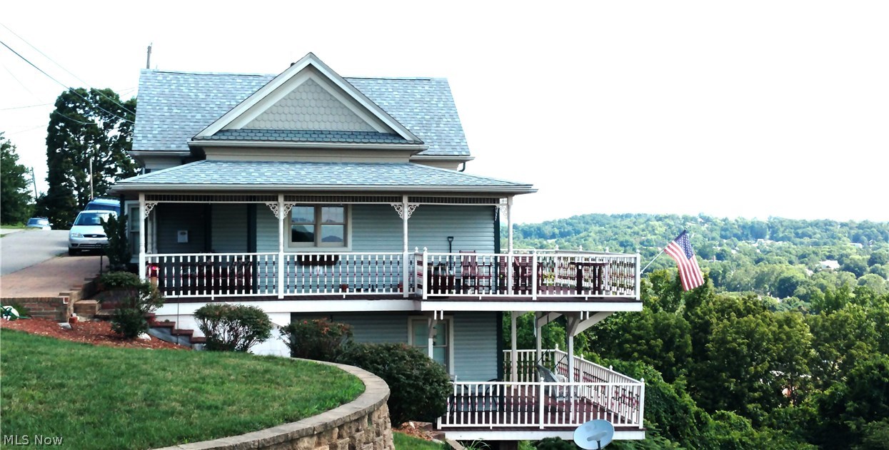 One of a kind completely remodeled in approx. year of 2000. Was built in early 1840 to 1900's. City would not allow to tear down and replace but gave permit for renovation. It was taken back to lath throughout, steal beam added in lower level, a beautiful built in bookcase with gas log fireplace in the large Living room with cathedral ceilings. Another built in china cabinet located in dining area. Kitchen has hickory cabinets and an island. The living room has a very large picture window for viewing the outside and to drink in the natural lighting. From the dining area you can walk out the sliding glass doors to a deck with maybe the most beautiful view of our city that you have ever seen. The staircase winds to a loft with additional bedroom and leisure space to enjoy. The lower level has the same window with a magnificent view as well and sliders from this master bedroom to its own private deck. Adjoining the master bedroom is a bath with both shower and whirlpool tub. Of