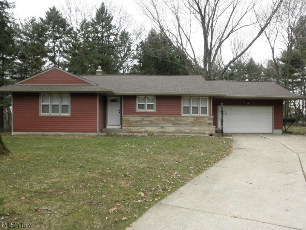 Completely updated inside and out in 2014! Charming ranch nestled on a private, .75 acre yard with mature trees. Stunning curb appeal shows all new vinyl siding and stone front with new gutters, roof and exterior doors. Most of the windows have been updated. Family-centric kitchen with corner dining with sunny windows. New Hampton Bay Cognac cabinets, stainless steel appliances, granite countertops, pantry and open bar to living room. Oil-rubbed bronzed faucets, door knobs and lighting fixtures throughout. Spacious living room with hardwood floors, wood-burning stone fireplace with custom wood cornice topped wall of windows. Enclosed 3 season sun porch with beautiful views and privacy. Updated main bath with new espresso vanity, granite countertops, wainscoting and vinyl floors. Hall cedar closet. Newly finished lower level family rooms boasts wood burning brick fireplace and new carpet. Additional lower level room perfect for an office or additional bedroom. Updated plumbin