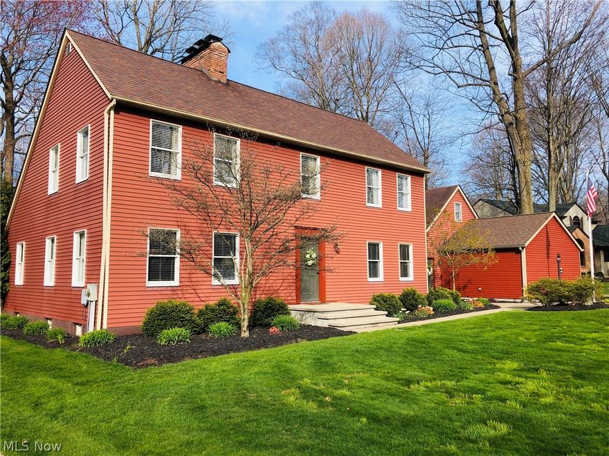 The home for which the neighborhood was built. This custom Saltbox, classic American Colonial architectural from the 1600s, remains a popular standard in New England. From the open fireplaces to peg-head Early American stained hard oak floors, it is authentic in style and feature. An original early American farmhouse. Entry foyer hosts 2 double closets, flanked by the office and family room. Dining hall with soaring vaulted ceiling and adjacent kitchen are open-concept, magnificently positioned as the heart of this home - and with a hearth. Blending elements of hewn beams and brick walls, this kitchen has a vintage farmhouse sink, and is upgraded with a Viking gas cook-top positioned in the spansive island. Plentiful cabinetry and large pantry accommodate this gourmet center. A wall of windows in the sun room looks out to patio, gardens, and forest. The Master quarters offers 3 double closets, crown molding and open fireplace, with double vanity and custom shower en suite. Two addition