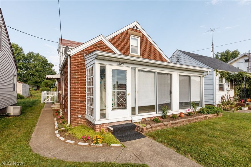 This quality built brick bungalow is ready for you to call HOME! Opportunity is knocking in this 3 bedroom home located in a great central Canton SW location! Home features hardwood floors throughout, updated vinyl replacement windows, central air, foyer entry with guest closet, spacious living room with decorative stone fireplace, formal dining room with beautiful glass chandelier and additional closet, sizable kitchen with appliances and large pantry with swing-out doors for added pantry space, gorgeous original stained wood trim and doors throughout, first floor bedroom with lighted closet and ceiling fan and first floor bathroom with built-in storage. The hardwood floors continue to the 2nd floor with wide middle hallway and 2 additional bedrooms with lighted closets. The sun room is a great place to relax and lends additional living space with sliding doors to enjoy the outdoors. Vinyl fence encloses the perfect backyard. Oversize garage with auto door opener, newer overhead garag