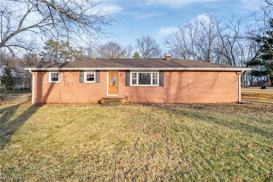 Desirable brick ranch on 2+ acres in Louisville. Back garage entry provides extra privacy. Kitchen has attractive modern cabinets, neutral finishes, white appliances, reverse osmosis system. Dining area is adjacent to kitchen and overlooks backyard. Large living room at front of home with wood floors. Bathroom and 3 bedrooms flow off the hallway at the back of the home. Bedrooms have wood floors. Most windows are replacement windows. The full basement is large and open. It is bright with natural light from glass block windows and high ceilings so there is a lot of potential for whatever you need space to do! Water filtration/reverse osmosis system in place. Hot water tank and sump pump were replaced in 2021. Wonderful outdoor living on over 2 flat acres, partly wooded, partly cleared. There is a shed on the property -- roof has caved in and will need repair. There is a volleyball net at the back of the property, the land is perfect for gatherings with room to roam.