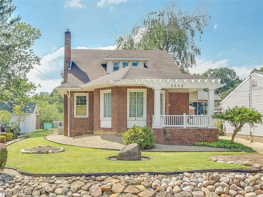 Impressive Brick Cape/Colonial in desirable Falls neighborhood. Appealing curb appeal with cozy front porch,concrete driveway and attractive landscaping. The front door steps into the cozy circular sun room. This home has been maintained in excellence, extensively remodeled and kept in pristine condition. Floor plan reconfigured and well planned out to create an open concept that is light and bright with the kitchen opened to the dining room with a bay window and the formal living room with a fireplace. Custom made weathered oak kitchen cabinets built on site with corian counters,white tile back splash, huge 96"island/breakfast bar,ceramic tile floor, stainless appliances, hidden trash and recycle containers, plus a wine rack! Gorgeous hardwood floors throughout the first floor,many rooms with crown molding, newer six paneled doors and most all light fixtures replaced too. Two spacious bedrooms on the first floor with double closets plus a beautifully  remodeled bathroom with double si