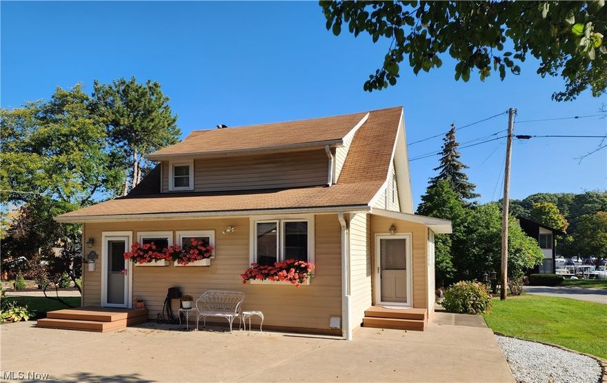 255 Yacht Club Drive in the heart of Old Rocky River within walking distance to CYC Yacht Club, fine restaurants & shopping! The home has accommodated and hosted many gatherings over the years and is seeking a new owner to carry on the lifestyle and traditions! This unique 3 bedroom home has views of the river, docks and boats as they gently pass by. An open floor plan with many recent updates. Stunning warm and inviting kitchen ideal for entertaining with a massive granite island, newer white cabinet refacing, stainless appliances and ceramic tile. Formal dining area with hardwood that leads to the large family room with warm wood burning fireplace. You won't want to leave the river facing 4-season sunroom with gas fireplace, walls of windows and access to the private paver patio and lushly landscaped rear yard. First floor laundry and half bath complete the downstairs. Upstairs you will find three cozy bedrooms and a full bath. Recent updates include windows, window treatments, kitchen & baths, doors and storm doors, re-built upper 3 car parking deck and much more. The home offers a basement useful for added storage and a 2.5 car garage with opener. Easy access driveway with parking right at your front door and turn around space for easy garage access with combined parking for up to 7 cars upper and lower. The property a qualifies for the voluntary Rocky River Historical Society. One Year Home Warranty included.