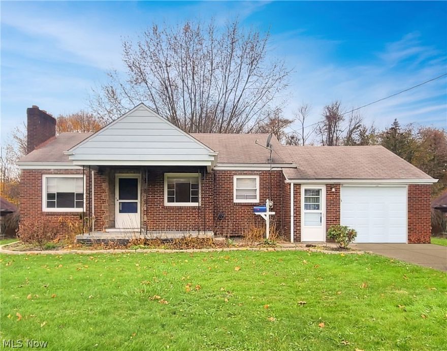 If you're looking for a great home in Struthers - Congratulations, you've found it!!  Take a look at this well-maintained, brick cape cod, sitting on nearly half an acre with the most serene, park-like setting.  Set back off the street and landscaped with love, the curb appeal of this home is next to none.   Take a walk around to the huge backyard, featuring a covered concrete patio, a custom-built brick fire pit and beautiful trees lining the rear of the property.  Enter through the one car, attached garage and into the updated kitchen, which offers stainless steel appliances (fridge 2014, stove 2018), attractive vinyl flooring (2020), updated light fixtures and an eat-in dining nook.  The large living room boasts a wood burning fireplace with a modern, distressed look, as well as ample natural lighting and newer carpeting (2018).  Also on the first floor are two bedrooms and a full bathroom.  The bathroom has been updated (2014) with gorgeous ceramic tile and a walk-in shower.  One o