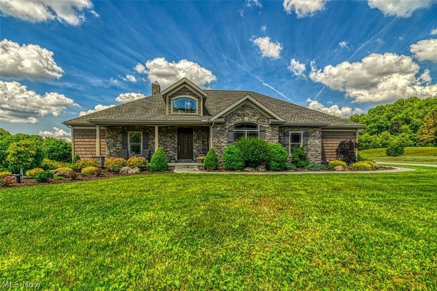Pride of ownership throughout this stunning 3200sf custom built ranch home with 3-4 bedrooms, 2 bathrooms and partially finished basement! Enjoy the perfect open floor plan. The custom kitchen, dining room and great room are a must see! A huge great room with vaulted ceiling greets you when you walk thru the front door to include a stunning stone, wood burning fireplace. The dining room has sliding glass doors that lead to a covered patio....perfect for morning coffee or watching the deer walk thru the back yard! Gorgeous custom woodwork throughout to include all cabinetry, trim and solid wood doors! Extra wide hallways and doors! Plenty of storage throughout with walk-in closets in all the bedrooms and a spacious 9 x 6 pantry right off the kitchen! Super sized first floor laundry / mud room too! The master suite includes a bayed sitting area, luxury bathroom with tiled shower and wonderful soaking tub! Large 2.5 car attached garage (24x31) too! Private, quiet nearly 2 acre gorgeously
