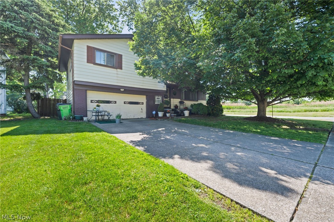 Pride of homeownership is evident in this well-maintained 3-bedroom home. The spacious living room, featuring a vaulted ceiling and decorative ceiling beam, opens into the dining room, creating a perfect space for entertaining friends and family. The family room is filled with natural light and adorned with a vaulted ceiling and wood beam, with access to the rear patio. The eat-in kitchen boasts ample wood cabinets, a large double sink, a stylish backsplash, and black appliances—all included. A half bath completes the first level. On the second level, you'll find three bright bedrooms with hardwood floors and spacious closets, along with a full bath featuring a vanity with storage and a tub. The finished rec room extends your living space, offering an ideal spot for movie or game nights with the family. This level also includes a laundry and storage area. Outside, you can unwind in the fully fenced rear yard with a patio area and a storage shed. An attached 2-car garage adds convenience to this charming home. Recent updates include first floor bathroom remodel, polished hardwood floors throughout, carpeted family room and installed new blinds and curtains, replaced the vinyl floor in the kitchen, replaced stove and microwave, and interior paint 2018-2019. Great location close to Sims Park, Briardale Greens Gold Club, local restaurants, shopping, and minutes to Downtown Cleveland.