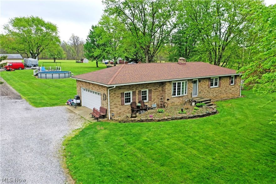 Turn your Farmhouse dreams into reality! This perfectly appointed Atwater residence doubles down with two floors of down home, rustic style that will be love at first sight within its advantageous, all-brick ranch construction. Set on an expansive lot and already configured with a large outbuilding garage and a livestock pen, this is turn-key country living at its finest with room to grow. Topping things off, a large above-ground pool is ready to be set up for summertime fun. Charm packed from the moment you enter the outstretched driveway, make your way past the two-car attached garage and front landscaping to gain access through the front door. Inside, a welcoming living room boasts soft carpets and tall windows that spill sunshine across the floors. Around the corner, the impressive, combined kitchen and dining space excites with an array of natural finished cabinets and a rolling island for easy prep and storage. Stainless appliances add to sparkle while a sliding barn door sits just past the dining room for additional pantry space. Down the main hall, three spacious bedrooms bring colorful and engaging surroundings to put you at rest. A must-see full bath is brightly lit with a daring, tiled shower.  Meanwhile at the basement level, a bonus rec room adjoins hidden storage and laundry, all while a second full bath delights alongside the finished lower family room. New furnace 2026, roof/windows/hot water tank 2013, waterproofed basement 2019, plus many more improvements done!
