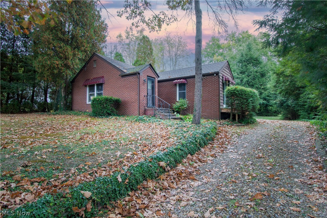Come see this lovely ranch tucked away on 1.02 acres in Norton! This charming home has many updates, a fresh/neutral color palate, newer laminate flooring, three bedrooms, two full baths, and many possibilities, including a three-car garage and outbuilding (24x20). The cozy and inviting living room showcases a wood-burning fireplace with built-in on both sides. A recently updated kitchen offers granite countertops, stainless appliances, subway tile, recessed lighting, and a dinette area. The master bedroom, with a walk-out, features a beautifully updated master bath. On the entry from the garage/deck to the house is the mudroom, which also has access to a walk-up attic for extra storage. The large deck (29x14) and treed backyard offer a shady retreat for outdoor entertaining & relaxing! Enjoy the privacy and quiet surroundings but not far from many amenities and close highway access for convenience in your commute! Some updates include a new furnace and Air conditioner, a new garage do