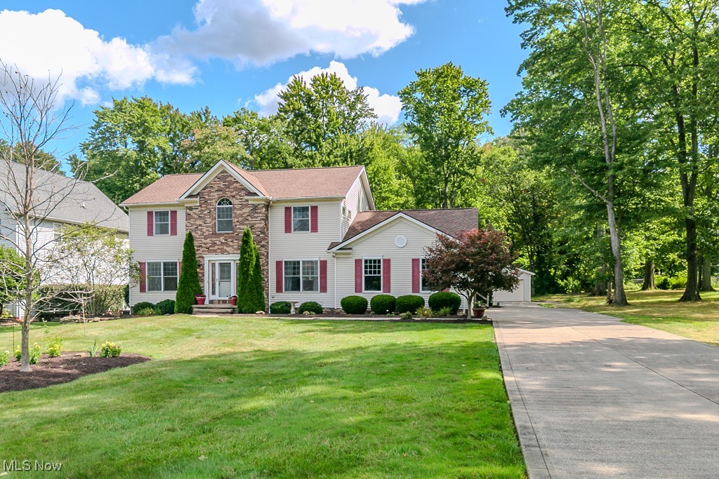 This is a rare opportunity to own a spacious six bedroom colonial with a hard to find private entrance two bedroom suite, perfect for multigenerational living. Set on over half an acre with a park like backyard and walking trails, this home has room for everyone. Step into the oversized foyer where you’re greeted by a recently updated great room with new carpet and a cozy fireplace. The open kitchen features beautiful cabinetry, granite countertops, a trendy tile backsplash, breakfast bar seating, and stainless steel appliances. A flexible room just off the kitchen could be used as a dining room, office, or formal living space.
Upstairs, you’ll find four freshly painted bedrooms and an updated full bath. The primary suite impresses with high ceilings, a walk in closet, and a private bath complete with step in shower and soaking tub. The finished lower level adds even more living space with a huge family room, half bath, exercise room, laundry, and generous storage.
The attached two bedroom suite offers its own entrance, an applianced kitchen, living room with bow window and space for dining, full bath, and direct access to the back patio, ideal for parents, adult children, or long term guests.
Additional highlights include an attached three car garage plus an additional two car garage, a relaxing patio, and major updates such as roof and gutters (2024), furnace and A/C (2020), and a 75 gallon water heater (2018). Located in Twinsburg, this home is point of sale compliant and has no HOA. Opportunities like this don’t come along often, so schedule your showing today!