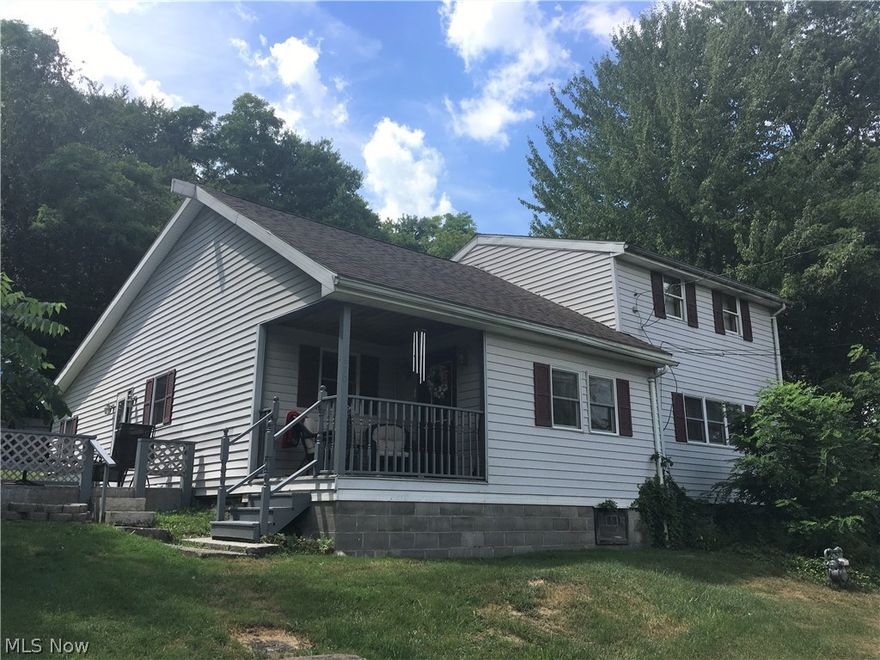 Beautiful updated century home in private setting on a 5 acre mostly wooded lot. Bright open updated kitchen with oak cabinets open to dining room leads into a large living room.  First floor features 2 bedrooms, 2 full baths and laundry, second floor has 2 additional bedrooms and storage room. Roof, furnace and A/C are approximately 3 years old, new HW heater. Relax on the large carpeted patio or cozy front porch.  Newly built 2-1/2 bay garage plus storage shed. Approximately 4 acres of property is wooded with back of property abutting Brookfield High School.