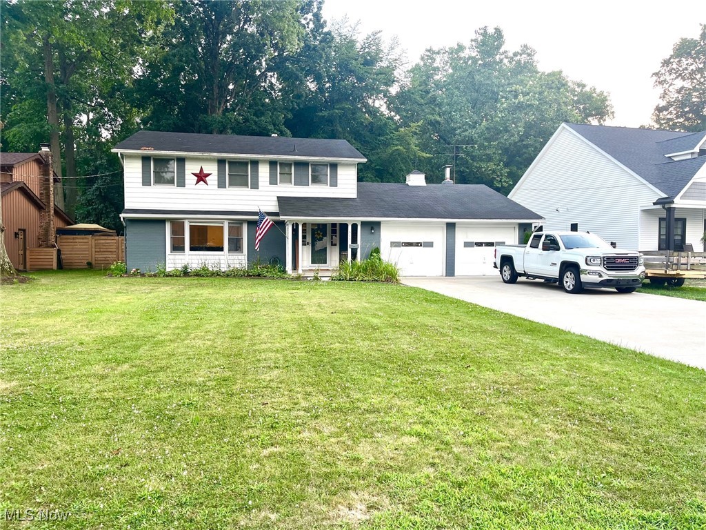 This beautifully maintained colonial that seamlessly blends charm, comfort, and modern updates sits on nature's doorstep. Enjoy peaceful mornings on the covered front porch as the neighborhood awakens. The long cement driveway leads to a 2-car attached garage, offering ample parking and storage, complete with a pull-down attic for additional convenience. Inside, a spacious layout is ideal for both everyday living and entertaining. The L-shaped living/formal dining rooms feature trendy laminate flooring, creating a perfect setting for memorable gatherings. The thoughtfully updated kitchen in 2020 includes LVT flooring, two pantries, and stylish gray cabinetry with roll-out drawers and modern hardware. The eat-in area lets you enjoy casual meals bathed in natural light, framed by a large bay window. The first-floor family room is a haven of relaxation, featuring sleek, dark hardwood flooring and a brick-front wood-burning fireplace (needs a liner) that anchors the space with its cozy ambiance. A slider opens to the patio and fully fenced backyard, where the grassy expanse meets a treed view of a ravine and creek, creating a breathtaking backdrop for outdoor enjoyment. A large shed provides additional storage for gardening tools & lawn equipment. Upstairs are four spacious bedrooms, including a primary suite with two closets and a private full bath. A second full bath in the hallway serves the remaining bedrooms. A full bath on the main level has been thoughtfully updated for handicap accessibility. The full, unfinished basement offers endless potential for future living space, currently a functioning workshop. Conveniently located near highways, shopping, and Lorain County Community College, this home is the perfect setting for your future memories. Don't miss the opportunity to make it yours. Additional updates include: washing mach. & HWT 2024, Dishwasher & Stove 2020, Furn & CAIR 2019, Dryer 2018.