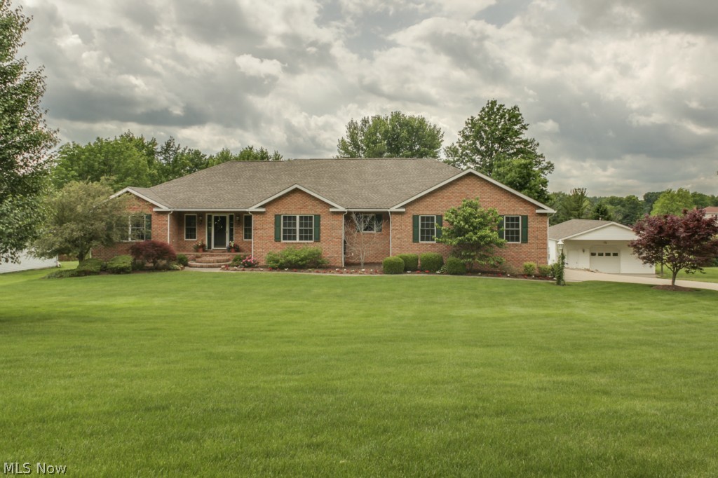 This Stunning Custom Built 4 bedroom, 3 1/2 bath Brick Ranch is breathtaking! The open floorplan has a vast kitchen with skylights that spills into the spacious, cathedral ceiling, great room. The bay windows in the dining room allow ample sunlight to flow in the room for special events, or to enjoy on a daily basis. Do you love woodwork throughout the home? This is the home for you! From the kitchen cabinets, to the windows, solid oak doors, 8" baseboard, and staggered sized oak flooring, this home is what you are looking for when it comes to detail and attention to hardwood. The basement is a 12 course and has a walk out that is ready for you to create your own oasis of living space. The landscaping is mature and gorgeous with a view of the lake. There is a 3 car extra deep/high attached garage and another workshop/garage that can hold more vehicles/equipment. This rare find is what you've been waiting for. Schedule your private tour today.