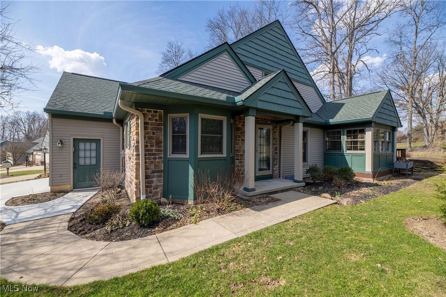 Welcome to the charming enclave of Hampton Court!   This 2BR/3.5 Bath stone and vinyl condo lives like a house with it's open floor plan brightened by loads of newer windows and skylights creating a bright and airy feeling!  The Eat-In Kitchen boasts a Breakfast Bar and S/S appliances. The two story Great Room is warmed by the Gas Fireplace w/Built-Ins and has access to your four season Sunroom!  Take the entertaining outdoors to your generously sized wood Rear Deck - with plenty of space for seating, grilling, relaxing.... Retreat to you First Floor owners suite w/ Walk-In Closet and lovely updated Master Bath!  A convenient Laundry Room and 1/2 bath complete the first floor.  Upstairs you will find a second Master Retreat with Walk-In Closet, Full Bath w/Skylights and Soaking Tub. Attic storage is easily accessible and there are additional closets in the Loft area - which could easily be converted to a 3rd Bedroom!  Downstairs you will find a huge Rec. Room warmed by another Gas Fireplace with access to a third Full Bath!  The two car garage w/Nature Stone flooring has another rare feature- a service door to the outside!  Lovingly maintained through the years, the original owners offer truly worry free maintenance HVAC 2024, H2O 2021, Windows 2022/23, Roof/Gutters 2024, Driveway 2024.  Nestled in the Greenwood Village community, enjoy the many social events, Recreation Center amenities, and serene location abutting the CVNP.  Welcome Home!