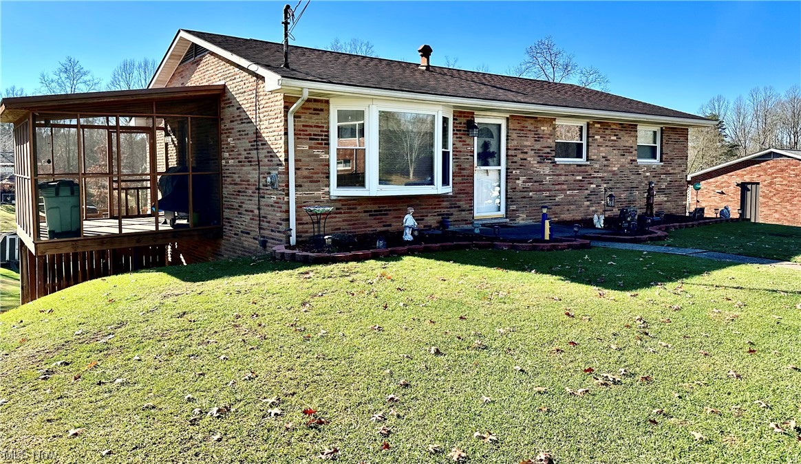 MUCH BIGGER THAN IT LOOKS. This 4 Bedroom, 2 Bath brick RANCH is situated on nearly a half acre lot in an established WILLIAMSTOWN subdivision. Easy access to the park, airport, and I-77 are just a bonus! This home offers a formal living room with a large bay window, and a generous dining area that connects to a spacious kitchen. You will love the screened back porch with steps leading down to a wooden deck to take in the view of the fantastic back yard. Three bedrooms and an updated bath finish out the main level. Head down to the basement for a fireside family room that is sure to be the perfect spot to hang those stockings and cozy up on cold nights. The fourth bedroom has sliding doors that lead to a concrete patio and adjoins a full bath. If you've been wanting to be in Williamstown, you better call today. This brick beauty is as good as gone.