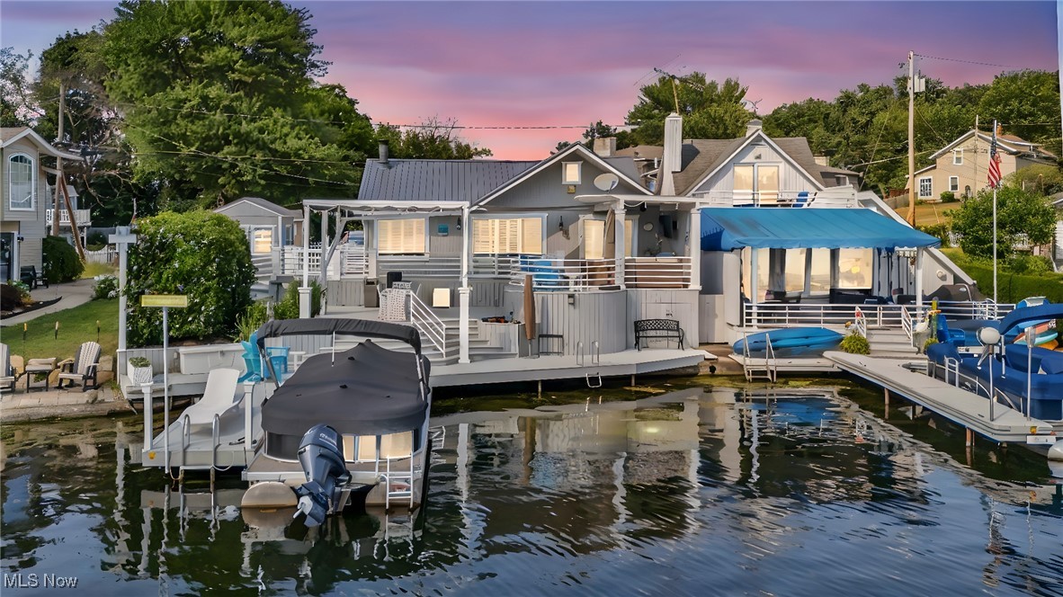 Your lake life starts here! This gorgeous lakefront ranch on West Reservoir—part of the Main Chain of Portage Lakes—offers 58’ of prime waterfront, a private dock, and rare parking for up to 7 cars. Thoughtfully designed for low-maintenance living, this home delivers the perfect combination of comfort, style, and year-round lake enjoyment.
Step outside and discover triple-tier lakefront entertaining areas that make this home truly unique. Relax in the custom-covered TV lounge just off the master suite, gather with friends in the circular sitting area, or dine al fresco in the grilling and dining zone. Deck seating right at the water’s edge, modern white railings, and in-deck solar lighting create a serene, upscale atmosphere—ideal for both daytime relaxation and evening sunsets.
Inside, the bright living room features a gas fireplace, crown molding, and large sliders framing the water views. The kitchen boasts a dimensional skylight, stainless steel appliances (gas stove, refrigerator), and cabinetry on all sides. The waterfront master suite includes a walk-in closet, custom crown accents, full ensuite bath, and private deck access with new sliding glass doors.
The lower level offers a second full bath, a semi-finished room with rec room, guest room, potential, laundry/storage, and under-deck storage for kayaks and canoes.
Major updates include a new metal roof, 2024 furnace, new carpet, ShadeFX retractable canopy with custom curtains, sliding glass doors, on-demand water softener, extended cement drive, custom 10’x12’ shed, solar dock lights, swimming cove, and more. Septic, well, and radon inspections are all complete and passed.
Move in and start your Portage Lakes adventure today!