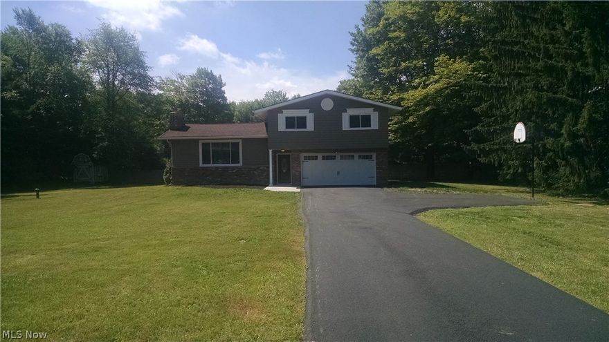 Bainbridge, Ohio...country within minutes of everything. If you want an "open floor plan" then this is the home for you.  This beauty has been completely remodeled, renovated and designed by an area interior designer.  Your eyes will take you from room to room enjoying the latest styles and materials while relaxing in the chic colors of gray and white that surround you.  Textures and "sparkle" stand out in this 3 br. 2 1/2 bath split level home.  The foyer porcelain tile floor begins your tour with hardwood in the main living area, bedrooms and luxury vinyl tile in the family room.  Besides "new" in every room, features include:  new doors interior and exterior, trim (baseboard and casing) garage door with opener(including keypad) window and man door, new double pane windows, new well pump, new concrete patio and newly paved asphalt driveway. The front and back yard of this property offers endless space for summer entertaining and fall clambakes.  Everyone has a story...begin yours her