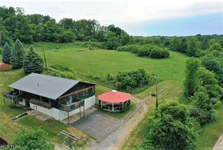 !Great Build site with potential rental income building on property!

Nearly 5 acres with potential of being a beautiful building site for a new home.  The land is 95% cleared and would provide a quite home site set back off the road. Minutes away from major highway, walking distance to bank, general store and local restaurant.

This unique property has a potential income producing building already built on the property situated in the front corner of the property. The building has 2 apartments upstairs and a large flex space along with 2 large garage spaces. 

Unit #1 is finished and Unit #2 is "roughed in" waiting for the future owner to put their stamp on the style when selecting all the finishes.  Unit #1 has 2 bedrooms and 1 full & 1 half bathrooms with open concept from kitchen into the living area.

Unit #2 is currently set up as a 1 bedroom and 1 full & 1 half bathrooms with a kitchen that is open to the living room area. This unit is a blank slate and could have second