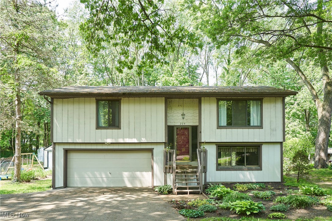 Nestled in the heart of Portage Lakes, this beautifully maintained 3-bedroom, 1.5-bath home is just a short walk to the lake and minutes from highways, Metro parks, shopping, and dining. Step inside to discover brand-new, plush carpet that adds comfort and warmth throughout the main level. The cozy kitchen features a dining area with access to a freshly painted deck, perfect for entertaining or relaxing outdoors. The full bath includes a tub/shower combo and a spacious vanity for convenience. Head downstairs to the lower level where you'll find charming wood-paneled walls, an electric fireplace, a half bath, and sliding glass doors that leadto your private backyard retreat. Don't miss this opportunity to own a charming home in one of Portage Lakes most desirable locations where comfort, convenience, and lake life come together.