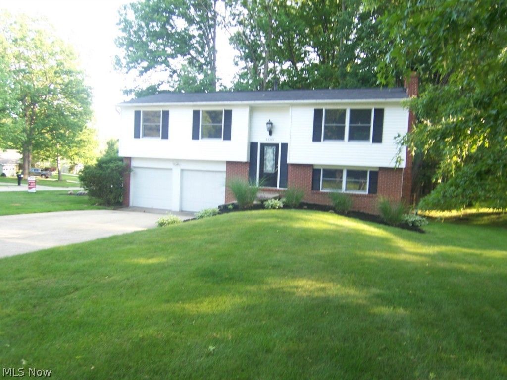 An open and updated Bi-Level with walk out lower level in the heart of Stow. This 3 bedroom 2 full bath home has an updated, open kitchen with newer cabinets, granite counter top, wood floors, formal dining, and lighting to impress anyone. Both bathrooms are fully updated. The roof is newer, with vinyl siding in 2013, furnace in 2009, and many more updates. The large living room is bright and open. The finished lower level features a bar and fireplace. There is an attached 2 car garage, deck, a master suite, and so much more.