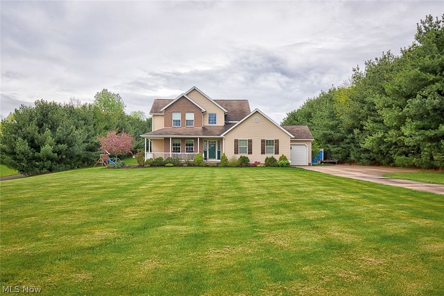 Welcome home to 11117 Wolf Ave., a GORGEOUS colonial home on 1.5+ acres in the Lake Local School District. On a quiet picturesque street, the long concrete drive leads you to your private oasis. Step onto your partial wrap around porch and inside you will instantly fall in love with the open 2 story foyer. Down the hall the living room features a stone gas fireplace and luxury pergo flooring that spans into the dining area and kitchen. The fully applianced kitchen offers 2 pantries, soft close drawers, granite counter tops and a huge island; great for hosting parties or making dinner for the family! French doors lead you onto your new concrete stamped patio (2021) with a gas firepit and views of your secluded tree-lined backyard! Back inside, you will find a first floor laundry room off the 3 car attached (heated) garage. A half bath, closet space, and a 4th bedroom/home office/playroom complete this level. Upstairs you will find new carpet (2019) and a large loft area; great space for a kid's nook! The master suite features 2 walk-in closets, dual sinks, and a large jetted shower/tub combo. 2 additional bedrooms and a full bath complete this upper level. The basement is partially finished and offers a great Rec room and on the other side there is a large storage area; perfect for your seasonal decor! The outside is freshly landscaped and features an additional 3+ car detached garage and a storage shed with a loft. Additional updates includes new AC and new furnace (2020), new well pressure tank (2017), exterior water hydrant (2021) and more! This beautiful home won't last long! Call today to schedule your private showing!